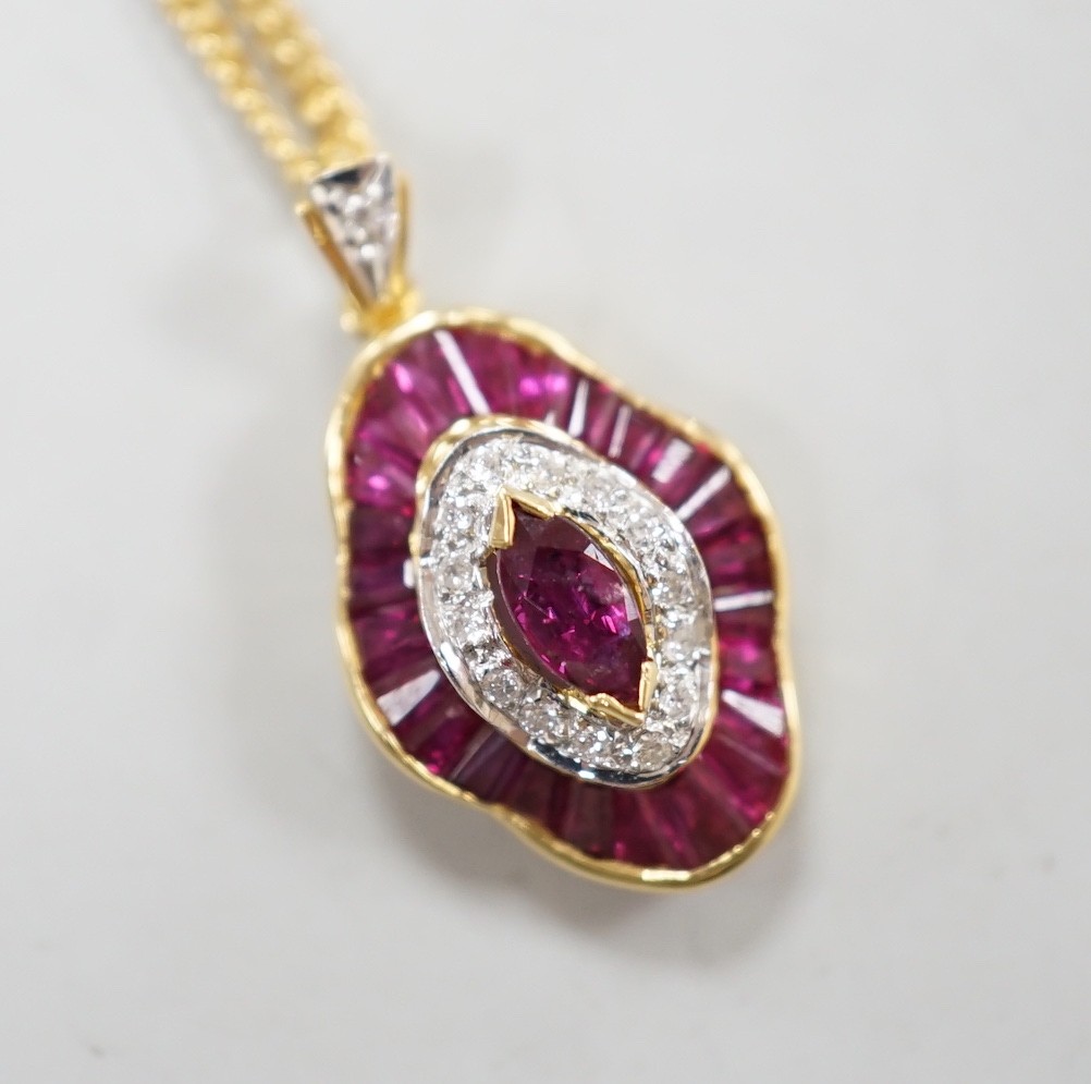 A modern 18k yellow metal, ruby and diamond cluster set quatrefoil shaped pendant, overall 25mm, on an 18ct gold fine link chain, 44cm, gross weight 8.1 grams.
